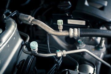 details of car engine, air-conditioning hoses and fittings, old film look effect, shallow depth of field