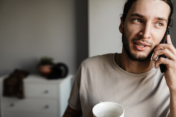Attractive young guy using mobile phone