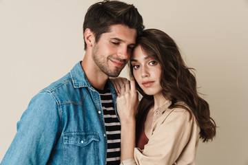 Image of young beautiful couple hugging and posing on camera