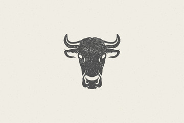 Black cow head silhouette with horns designed for meat industry hand drawn stamp effect vector illustration.