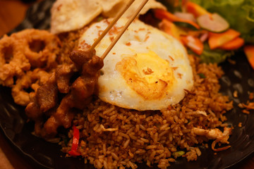 fried rice in plate on table in restaurant