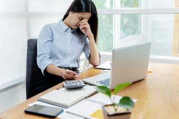 Woman tired and Stressed at workplace.