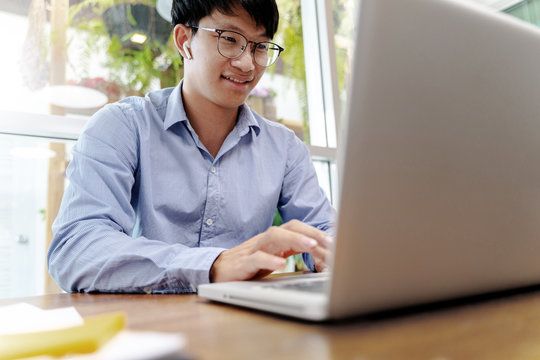 Happy asian man chatting with video conference.