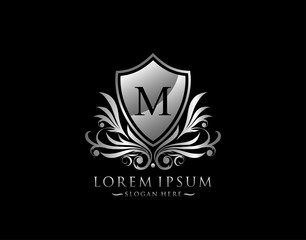 Luxury Shield M Letter Logo. Graceful Elegant Silver shield icon design.