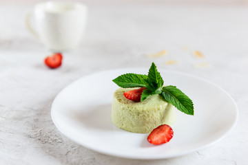 Avocado panna cotta with strawberry pieces and mint leaves. Sugar, lactose, gluten free. Healthy...