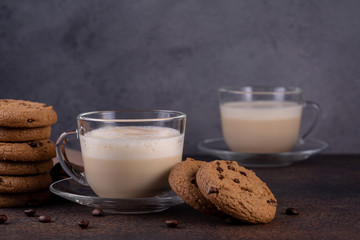 Two cups of coffee cappuccino with chocolate cookies. 