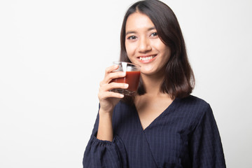 Fototapeta premium Young Asian woman drink tomato juice.