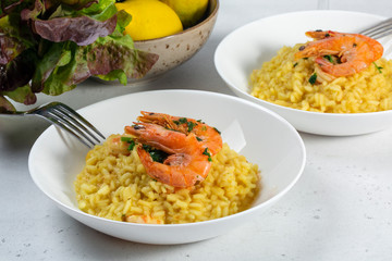 Risotto with shrimp and lemon. White background.