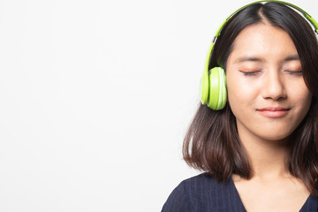 Pretty asian girl listening music with her headphones.