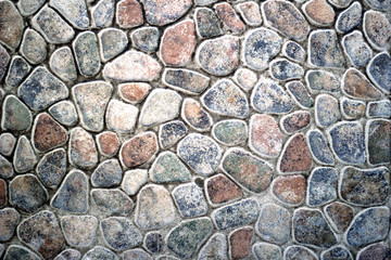 A wall of round and oval stone. Background.