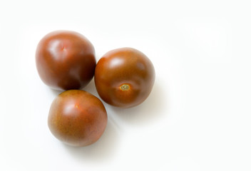 Three dark red fresh tomatoes whole and slices isolated on white background.