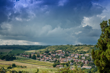 Beautiful rural summer landscape, green fields and small village in Serbia, Balkan countries