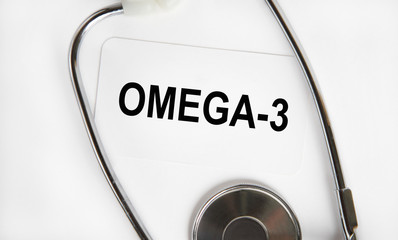 OMEGA-3 - the inscription on the business card, next to the stethoscope. A medical concept.