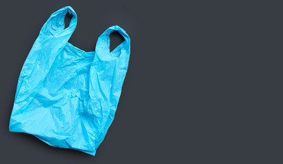 Blue plastic bag on black background.