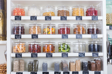 Image of showcase with dried fruits in containers in the store.