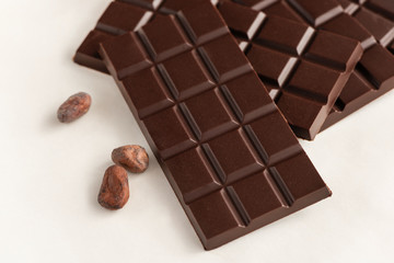 Bar of chocolate and cocoa beans.