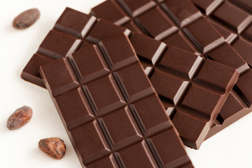 Bar of chocolate and cocoa beans.