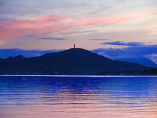 Summer night mountain landscape with Pyramidenkogel on Lake Woerther, Carinthia, Austria. Beautiful view of the lakes at sunset in Klagenfurt.