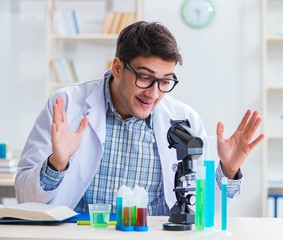 Young chemist student working in lab on chemicals