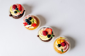 chocolate cupcakes with cream and fresh berries