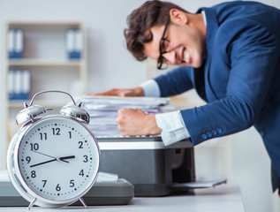 Businessman making copies in copying machine