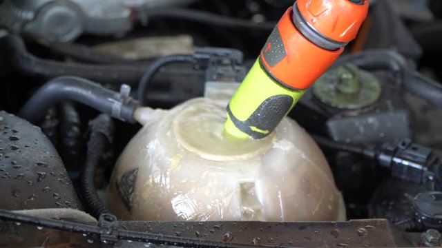 Add water to the car radiator is boiling.