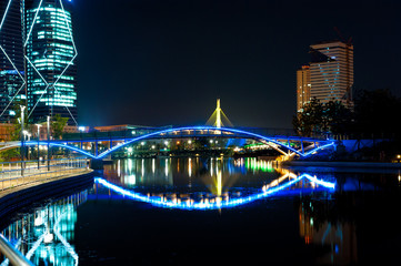 Night view of the colorful bridge and cityscape.