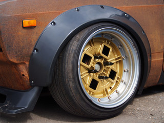 Rubber car tires on cast wheels designed for auto racing, close-up. Mechanisms and aggregates of...