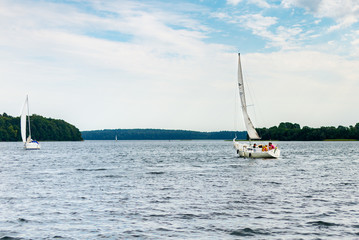 Plateliai Lithuania 08 24 2020 Old expensive vintage wooden sailboat sailing under dramatic sky before the thunderstorm.