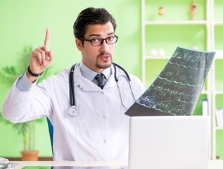 Doctor radiologist looking at x-ray scan in hospital