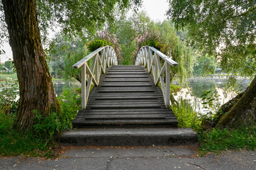 wooden bridge over water in beautiful park