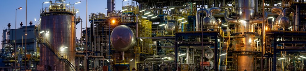 Installations of a modern refinery at night - panoramic view