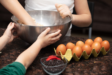 Kids baking cookies in house kitchen . Close-up child`s hands preparing cookies using cookie.