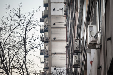 Air Conditioning Units, or AC, on display with their fans on a decaying facade of an old building of Belgrade, Serbia, Europe. They are used to cool down interiors, but consume a lot of electricity