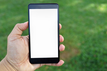 Close up adult hand holding a blank screen smartphone in the park