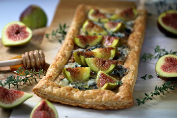 Puff pastry biscuit with figs, Camembert cheese and poured with honey.