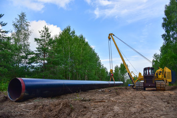Pipelayer with side boom Installation of  gas and crude oil pipes in ground. Construction of the gas pipes to new LNG plant.