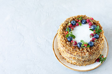 Carrot cake decorated with berries and figs on a white plate. Traditional donkey pastries. Copy space