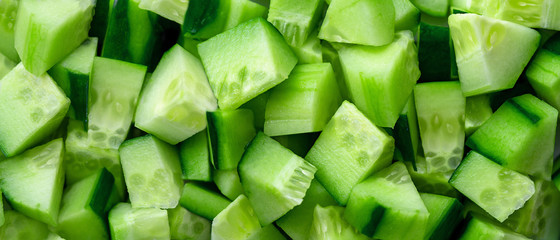 ingredient for salad. close-up view of dice of Cucumber, diced Cucumber background. Macro view of vegetable. Panoramic texture