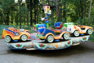 children's attraction cars carousel in the Park © Margarita