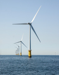 Wind turbines in an offshore wind farm in the North Sea just off the coast of the Netherlands, on a...