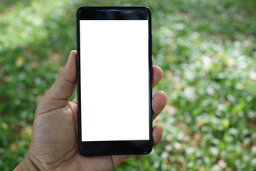 Close up adult hand holding a blank screen smartphone in the park