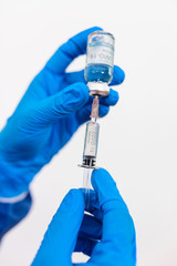 doctor or nurse wearing ppe suit in hospital with an injection vaccine for covid-19 or corona virus patient. Corona virus, Covid-19, virus outbreak or medical mask concept