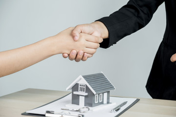 Fototapeta na wymiar hands shaking after Real estate agents explains a business contract, lease, purchase, mortgage, loan, or home insurance to buyer
