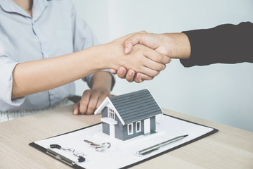 hands shaking after Real estate agents explains a business contract, lease, purchase, mortgage, loan, or home insurance to buyer