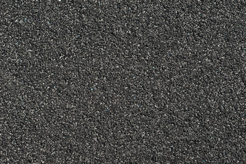 Texture of a rubber treadmill. Black floor in the stadium close up.