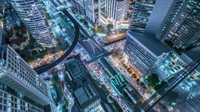 Time lapse Aerial view and top view of traffic on city streets in Bangkok , Thailand. Expressway with car lots. Beautiful roundabout road in the city center.