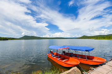 Fototapeta na wymiar Small fisher boats at the harbour in iver water in thailand blue sky with clouds beautiful and island mountain background landscape - Plastic boat