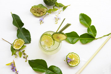 herbal healthy drinks iced kaffir lime cocktail water with bergamot slice local flora of asia arrangement flat lay style on background white - obrazy, fototapety, plakaty