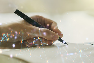 Creative concept of wireless technology and man hand writing in notebook on background. Big data...